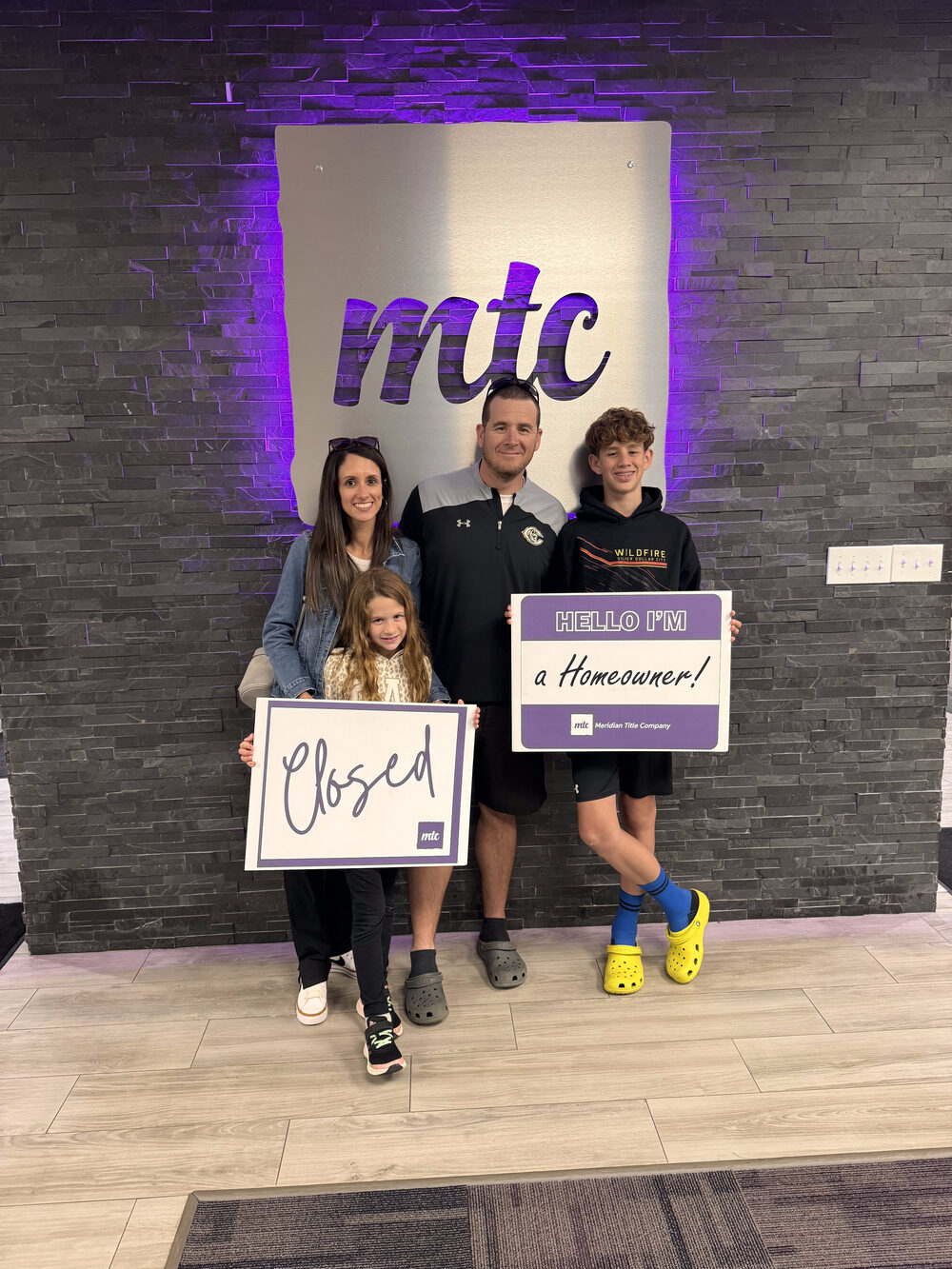The Clark family, U.S. Air Force retired, at closing on their home with Brian Fisher